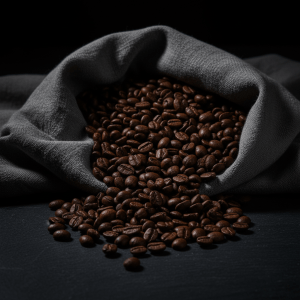 Editorial dark photograph of premium Colombian coffee beans spilling from a linen cloth on a dark slate surface, moody chiaroscuro lighting, macro detail, glossy medium roast beans, luxury magazine style, deep blacks