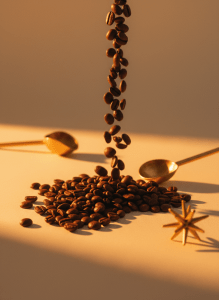 Editorial mid-century modern close-up photograph of glossy roasted coffee beans spilling across a warm cream surface, dramatic warm amber side lighting, shallow depth of field, retro premium aesthetic, tall vertical composition
