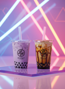 Vibrant editorial photograph of two bubble tea drinks side by side — one classic taro purple, one brown sugar tiger milk tea — in clear cups with wide straws, tapioca pearls visible at the bottom. Shot on a glossy pastel pink surface with dramatic neon accent lighting from behind. Gen Z aesthetic meets luxury product photography, ultra sharp, vivid colors, editorial magazine cover quality.